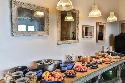 a table with many bowls of food on it at Le Clos Du Buis in Bonnieux