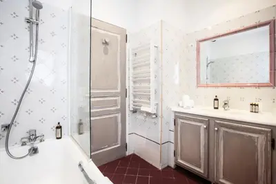 a bathroom with a shower and a tub and a sink at Le Clos Du Buis in Bonnieux
