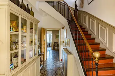 a staircase in a home with a hallway and a stair case at Le Clos Du Buis in Bonnieux