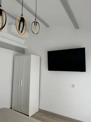 a living room with a tv and a cabinet at Villa hortensia in Carpentras