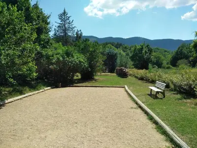 a park bench sitting in the middle of a field at Lou Vergié Maison Provencale au pied du Luberon in Saint-Martin-de-Castillon