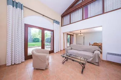 a living room with a couch and a table at Le Relais Du Grand Logis in Mirabeau