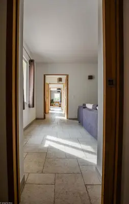 an empty hallway with a room with a bed and a floor at Campagne Cérès in Le Puy-Sainte-Réparade