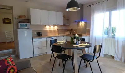 a kitchen with a table and chairs in a kitchen at B&B La Badelle in Gordes