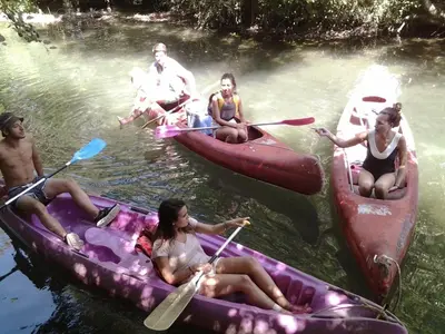 a group of people on rafts in the water at maison près de l'eau in LʼIsle-sur-la-Sorgue