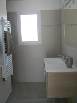 a bathroom with a sink and a window at Le Jardin des Tourterelles in Robion en Luberon
