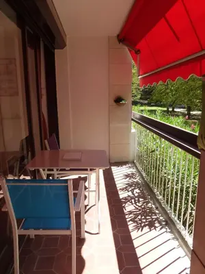 a patio with tables and chairs on a balcony at Apartment Les Muriers Blancs in Aix-en-Provence