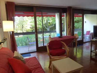 a living room with a couch and a table at Apartment Les Muriers Blancs in Aix-en-Provence