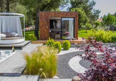 a garden with a tiny house in the middle at Mas des Cigales in Eygalières