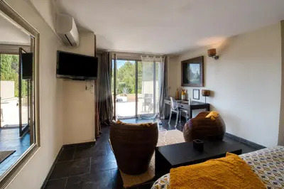 a living room with a couch and a table at Mas des Cigales in Eygalières