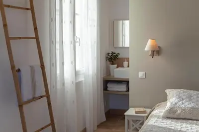 a bedroom with a ladder next to a bed and a window at Chambre d'hôtes le Mirail in La Motte-dʼAigues