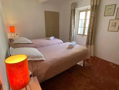 a bedroom with two beds and a window at Domaine Saint Jean in Saint-Saturnin-les-Apt