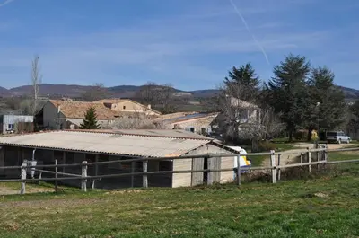 a barn with a tin roof in a field at Le Petit Labouret in Revest-du-Bion