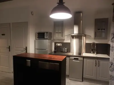 a kitchen with a counter top and a light at Mas les vieux chênes in Lambesc