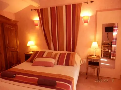 a hotel room with a bed and two lamps at Mas les vieux chênes in Lambesc