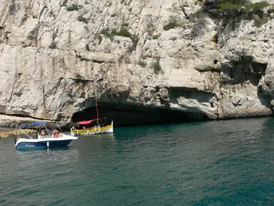 two boats in the water next to a cliff at Gîte chez Cécile à Lagnes, aux portes du Luberon in Lagnes