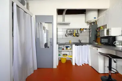 a kitchen with a door open to a kitchen with a counter at Appartement le Platane in Pertuis