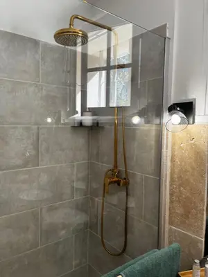 a shower with a shower head in a bathroom at Le Mas de Trévouse in Saint-Saturnin-lès-Avignon