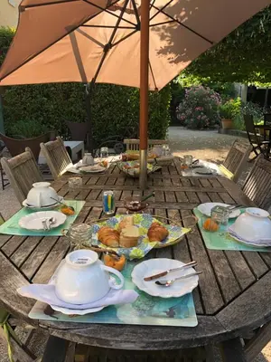 a table with a teapot and plates of food on it at Le Mas de Trévouse in Saint-Saturnin-lès-Avignon