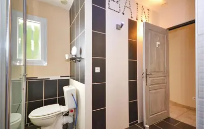 a bathroom with a toilet and a window at Beautiful Home In Maubec in Maubec