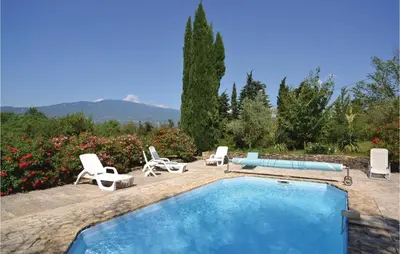 a swimming pool with lounge chairs and a swimming pool at Cozy Home In Crillon Le Brave With Wifi in Crillon-le-Brave
