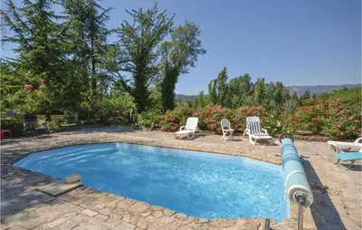 a swimming pool with two chairs and a table at Cozy Home In Crillon Le Brave With Wifi in Crillon-le-Brave