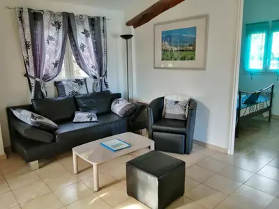 a living room with a couch and a chair at L'oustau des euses in Bédoin