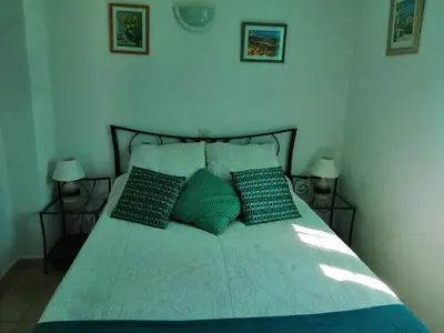 a bed with two pillows on it in a bedroom at L'oustau des euses in Bédoin