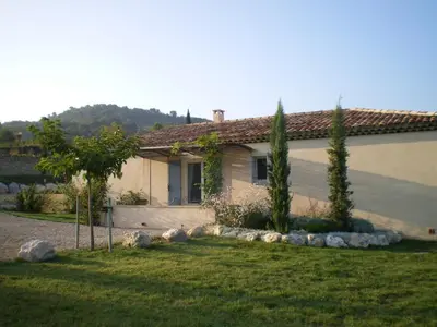 a house with trees in front of a yard at Cerise en Provence in Venasque