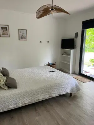 a bedroom with a bed and a flat screen tv at L'atelier des Coudelières in Le Thor