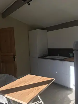 a kitchen with a table and a counter top at L'atelier des Coudelières in Le Thor