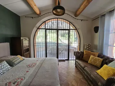 a living room with a bed and a couch at La Petite Yolande in Aix-en-Provence