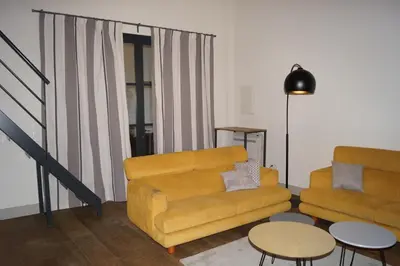 a living room with a couch and a table at Domaine de la Girafe in Eyragues