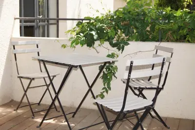 two chairs and a table on a patio at Domaine de la Girafe in Eyragues