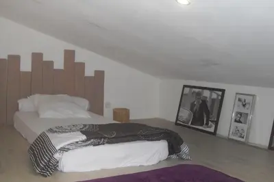 a bedroom with a bed with a wooden headboard at Lou mas li Pitchoun 