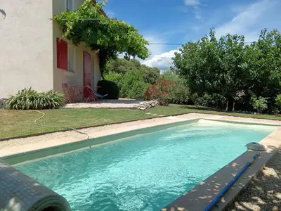 a swimming pool in front of a house at Le Petit Mas des Hauts de Beyssan, Maison de vacances avec piscine privative pour 2 personnes in Gargas