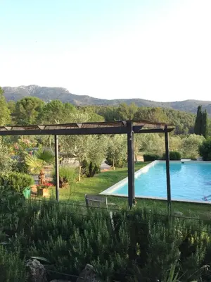 a pool in a yard with a pergola and a swimming pool at Au Havre De Paix sainte victoire vauvenargues in Vauvenargues