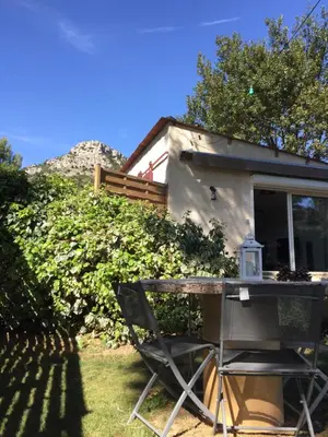a table and a chair in front of a house at Au Havre De Paix sainte victoire vauvenargues in Vauvenargues
