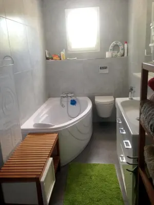 a bathroom with a tub and a toilet and a sink at Villa charmante à Eyragues avec piscine privée in Eyragues
