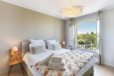 a bedroom with a bed and a large window at Villa Briali Pont Royal in Mallemort