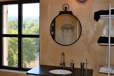 a bathroom with a sink and a mirror on the wall at Mas Ste Hélène in Céreste