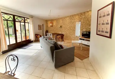 a living room with a couch and a table at Côté Provence in Le Thor