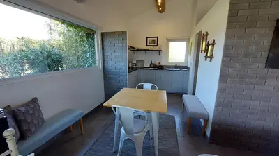 a kitchen and dining room with a table and chairs at Le Mas Des Bardes in Pernes-les-Fontaines