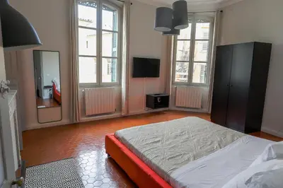 a bedroom with a bed and a large mirror at L'Oustau D'Alberta in Aix-en-Provence