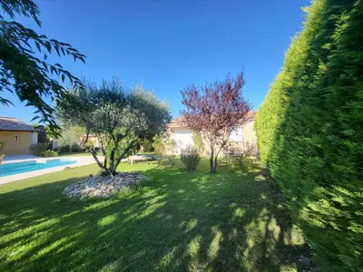 a swimming pool in front of a house at Petit gite de Provence in Mazan