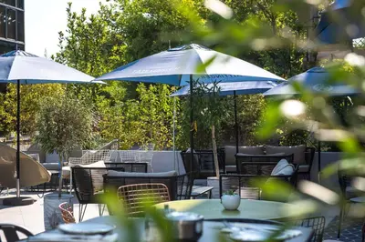 a group of chairs and a table on a patio at Radisson Hotel Aix En Provence in Aix-en-Provence