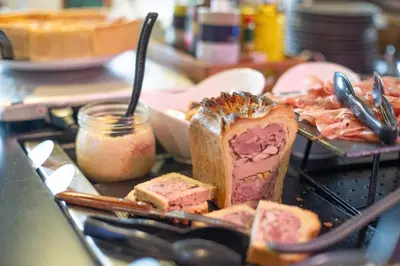 a plate of food with a piece of bread and meat at Campanile Prime - Aix-en-Provence Sud - Pont de l'Arc in Aix-en-Provence