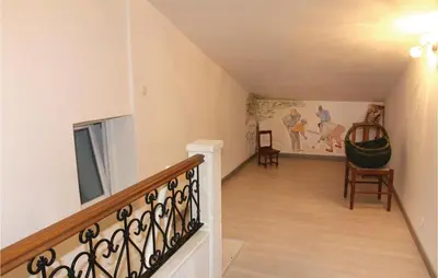a staircase in a home with a painting on the wall at 3 Bedroom Stunning Home In Gordes in Gordes