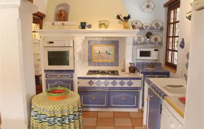 a blue and white kitchen with a stove top oven at 3 Bedroom Stunning Home In Gordes in Gordes