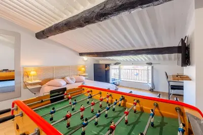 a room with a toy soccer game on the floor at Appart Hypercentre CLIM 2chb QuartierChic in Aix-en-Provence